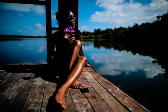 woman sitting near body of water