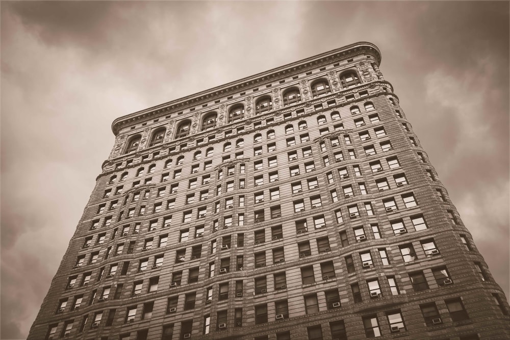 low angle sepia photography of a high-rise building