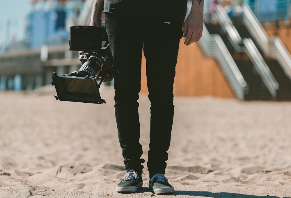 person holding shoulder-mount camcorder