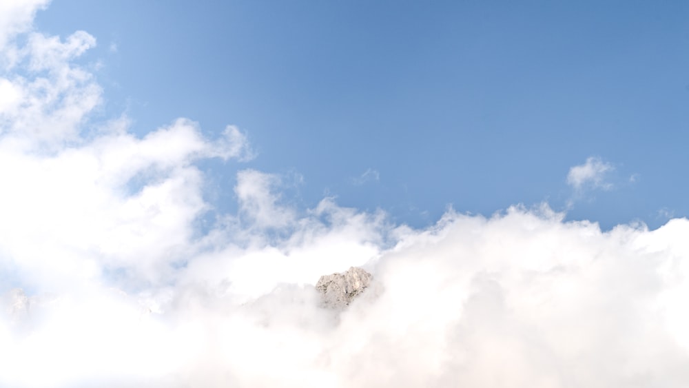 mountain between clouds