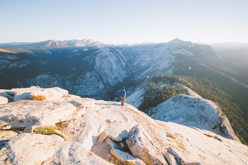 person standing on mountain during daytime