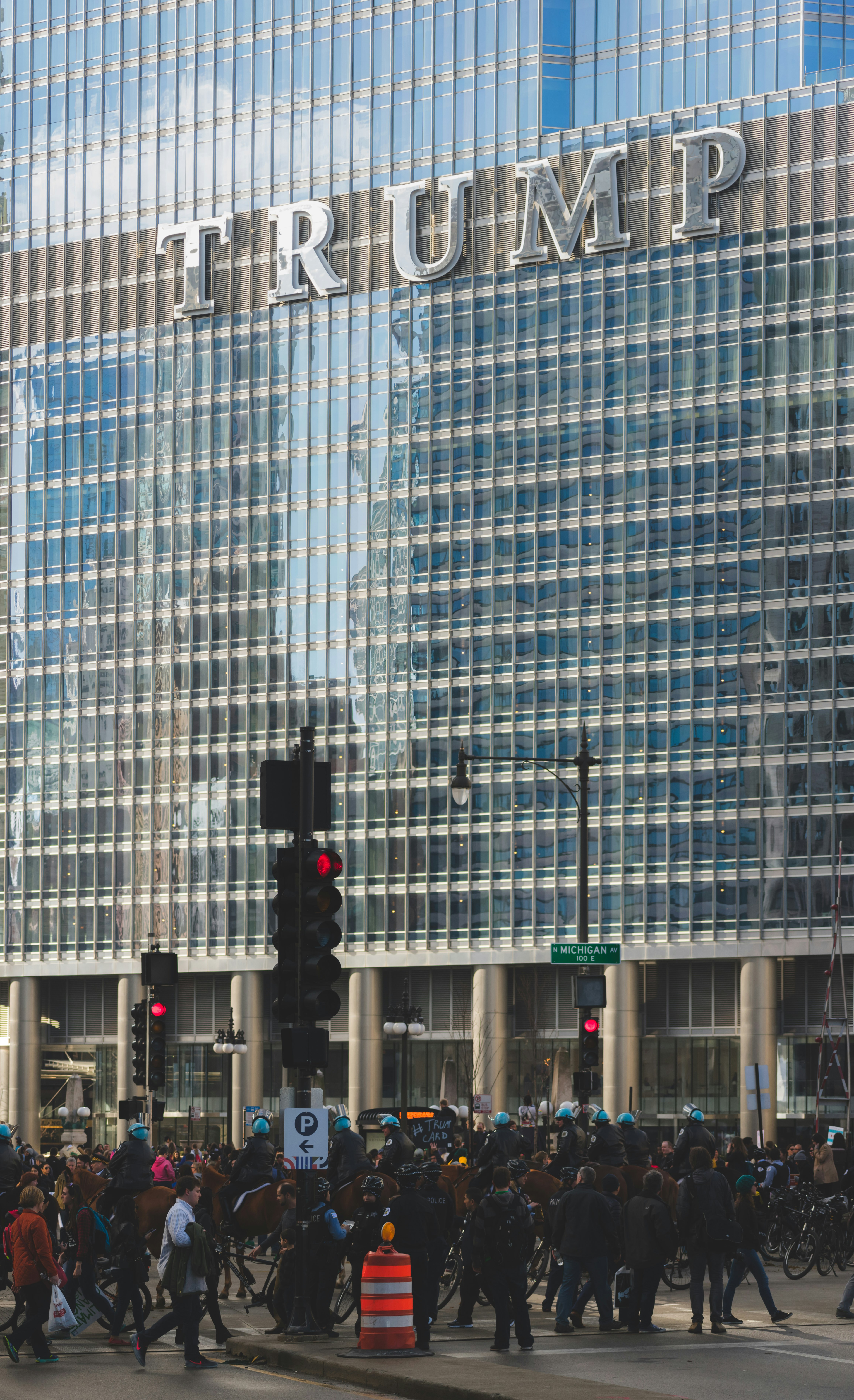 people walking on road beside Trump building