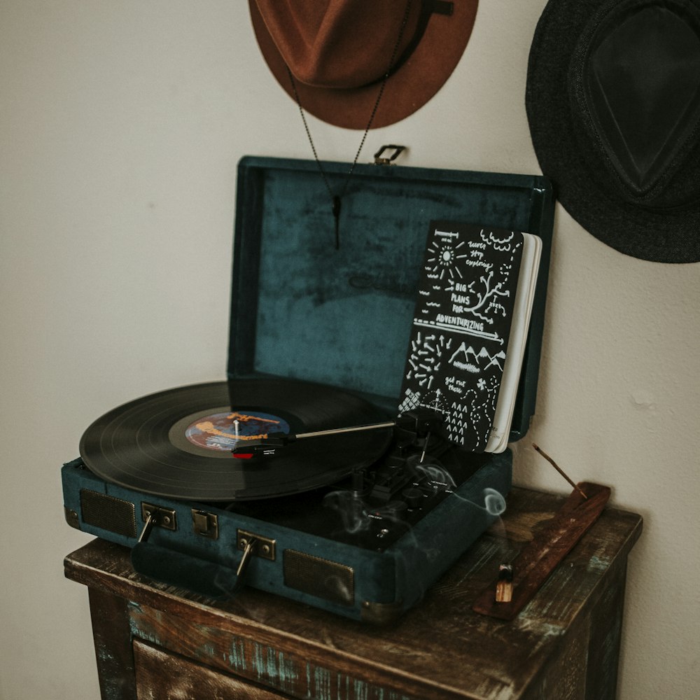 black and blue turntable on brown wooden side table