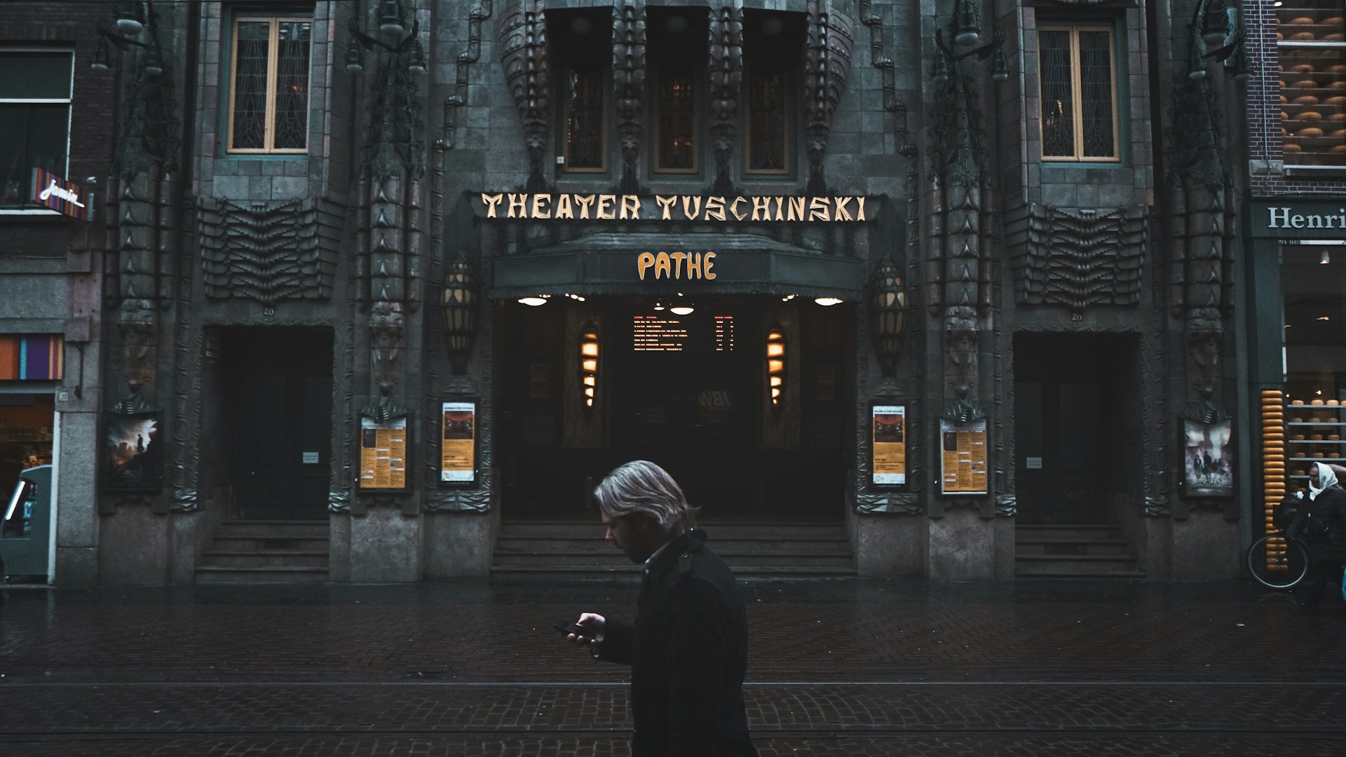 man standing near Theater Tuschinski building
