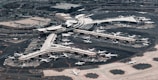 An aerial shot of a busy airport with planes on the runway.