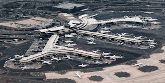 Aerial view of a bustling airport with planes and travelers.