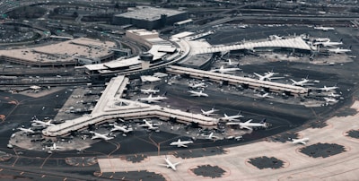 Aerial view of a busy airport with planes and travelers.