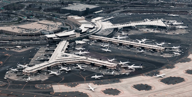 Aerial view of a bustling airport with planes and travelers.
