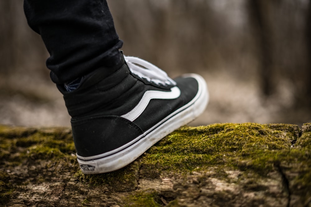 person wearing black and white Vans Sk8-Hi photo – Free Footwear Image on  Unsplash