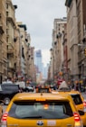 yellow cab in between of building