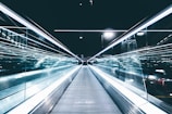 gray conveyor between glass frames at nighttime