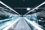 gray conveyor between glass frames at nighttime