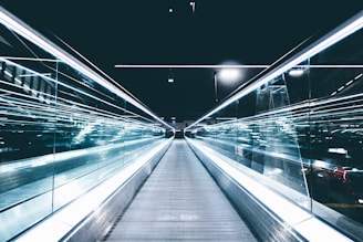 gray conveyor between glass frames at nighttime