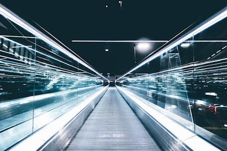 gray conveyor between glass frames at nighttime