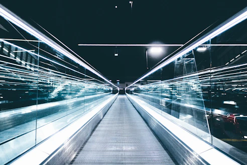 gray conveyor between glass frames at nighttime