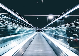 gray conveyor between glass frames at nighttime