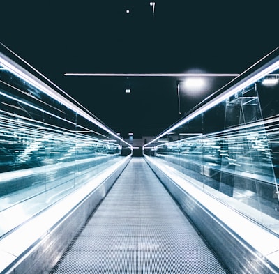 gray conveyor between glass frames at nighttime