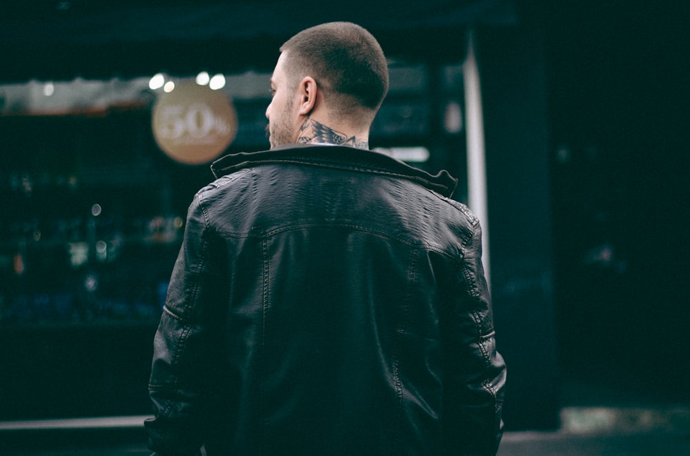 man wearing black leather jacket