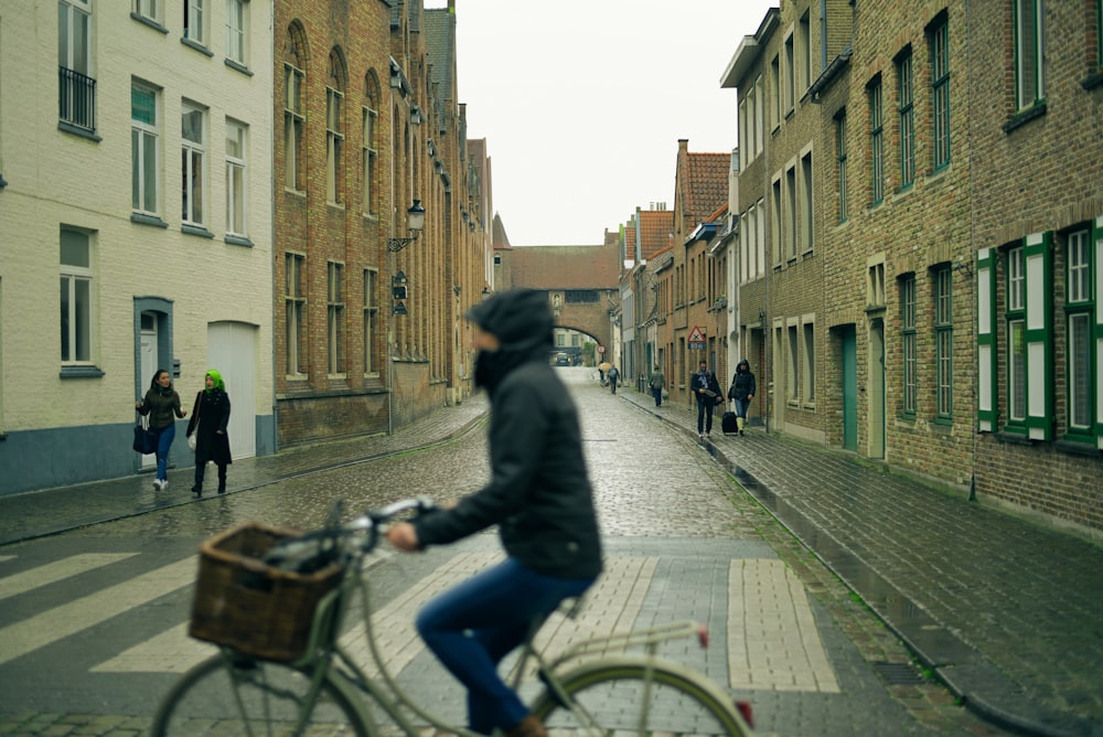 selective photography of people walking on sidewalks at side of buildings view from person riding city bicycle