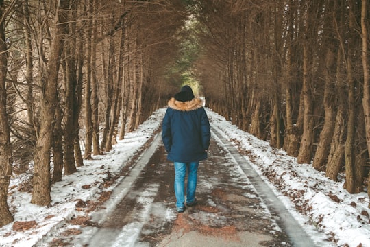 person walking on road covered snow in Vermont United States