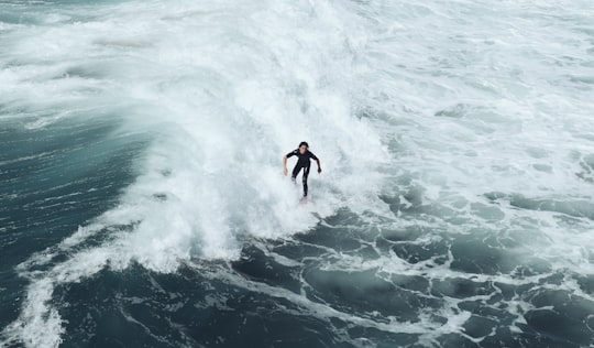 person surfing at waves in Huntington Beach United States