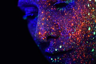person with assorted-color paint on face