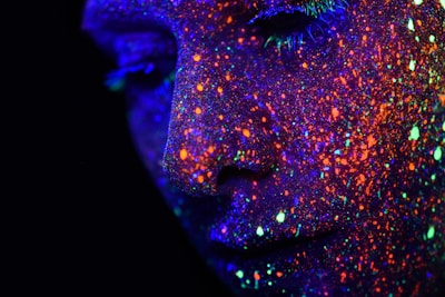 person with assorted-color paint on face