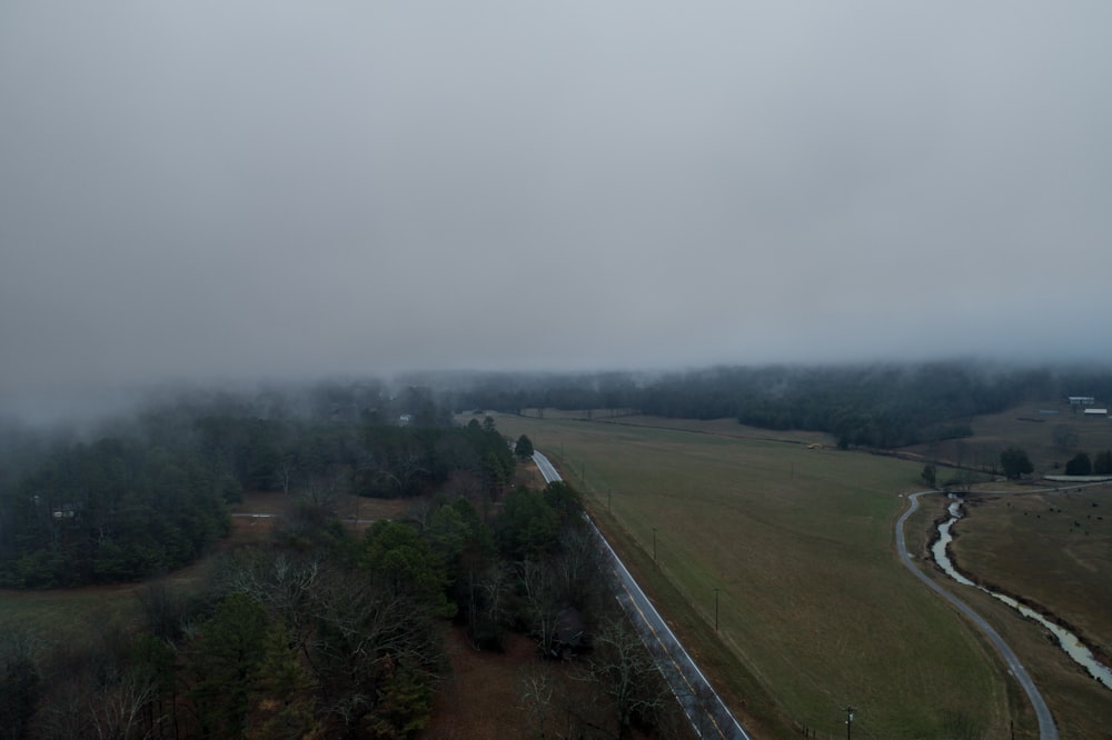 bird's eye view of road with thick fog during daytime
