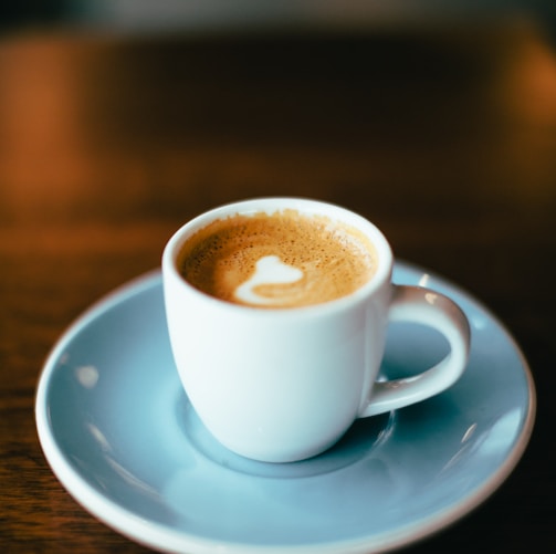 selective focus photography of latte in teacup