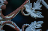Close-up of detailed ironwork with rustic finish.