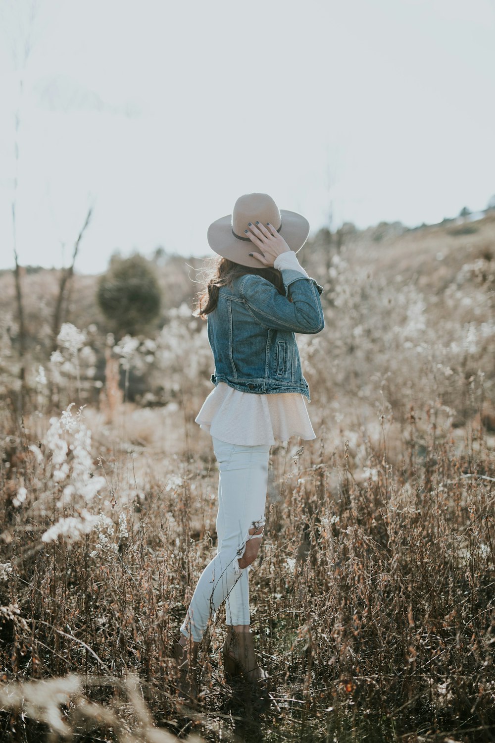 woman facing hill during daytime