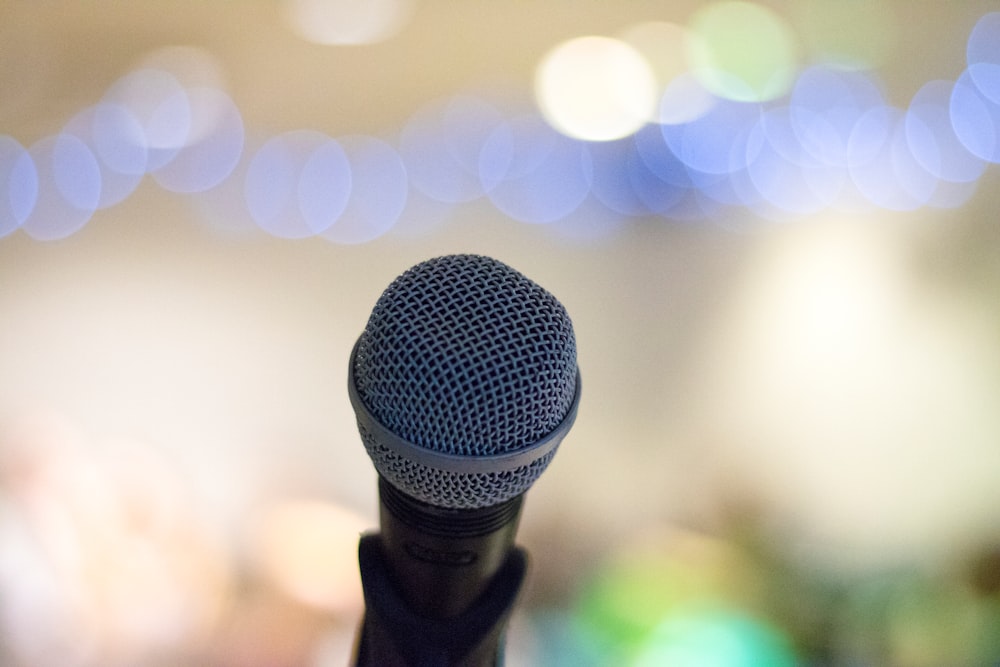 A microphone from the perspective of the presenter. The audience and background is out of focus