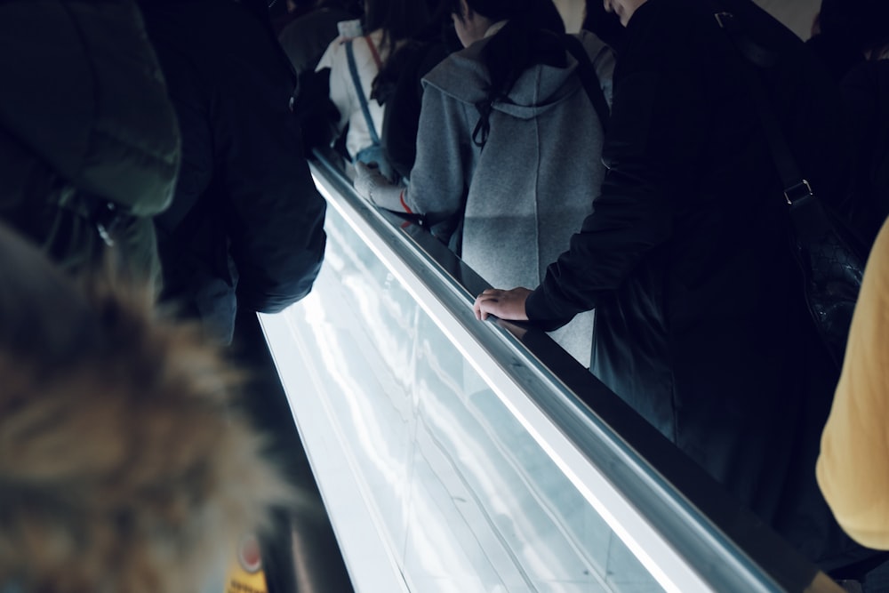 people on elevator inside building