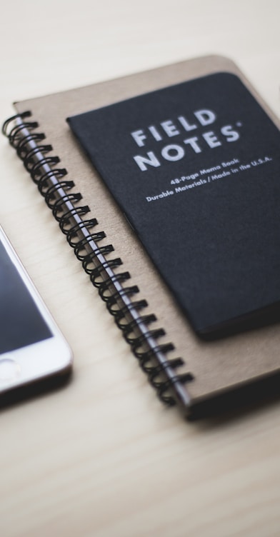 silver iPhone 5s near Field Notes book