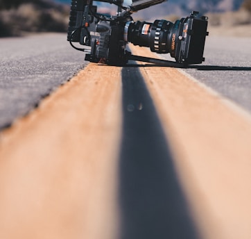 black shoulder-held camcorder on road