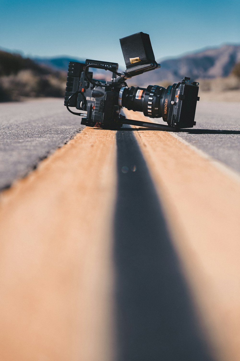 black shoulder-held camcorder on road