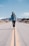 man walking in the middle on road at daylight