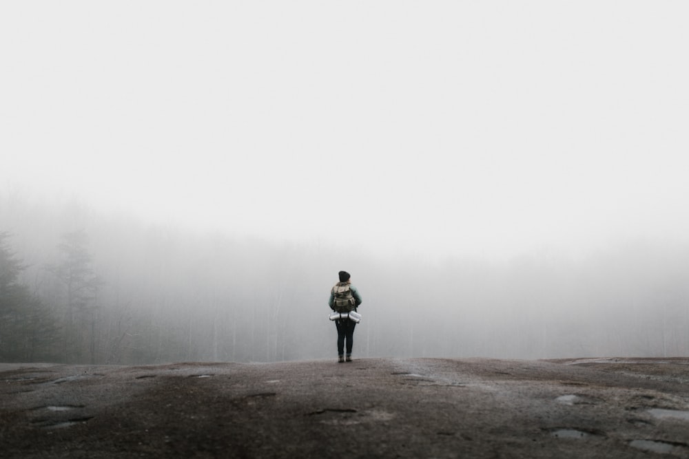 person standing in front of trees