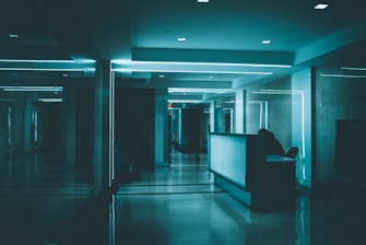 white wooden desk on hallway inside building
