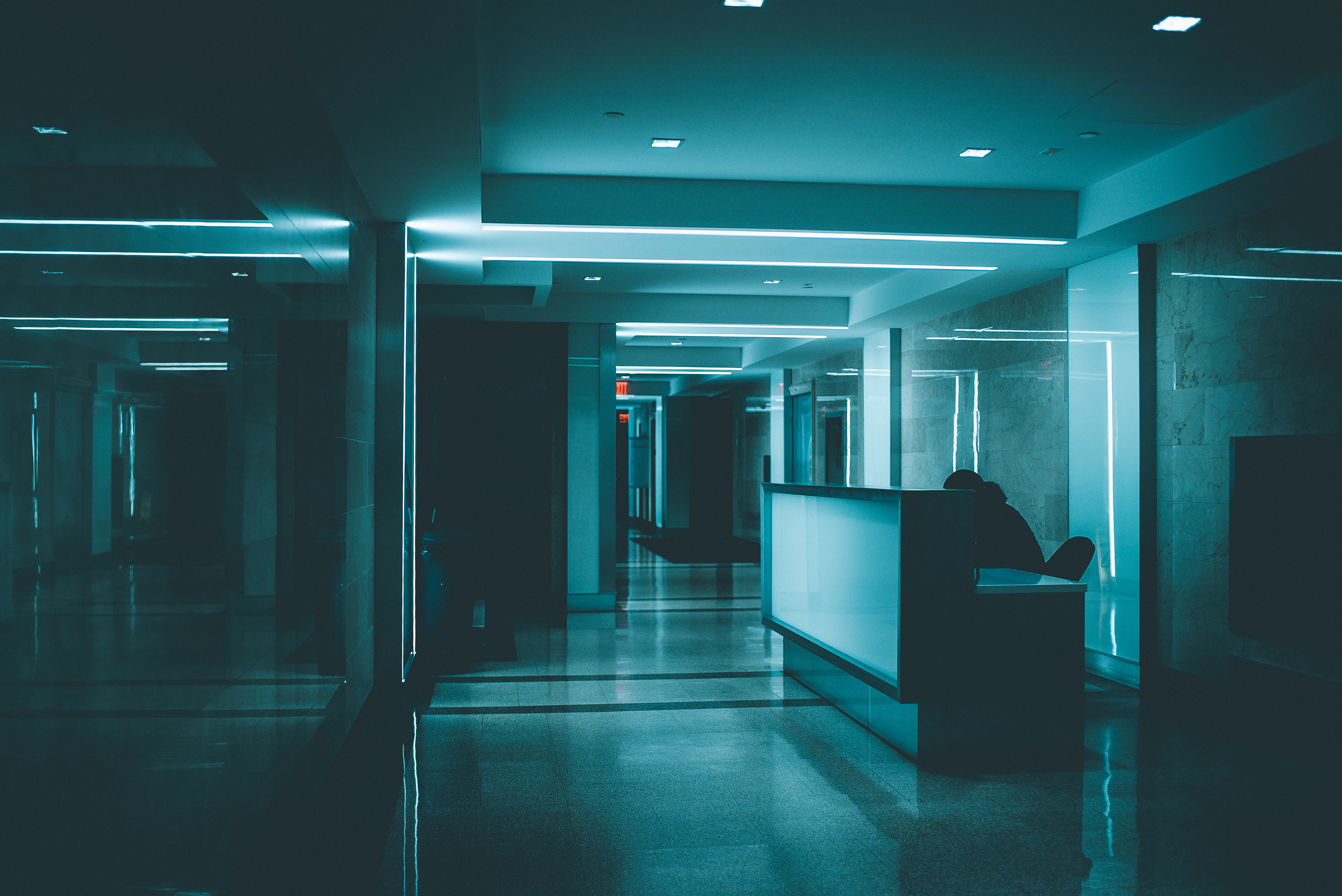 White wooden desk on hallway inside building