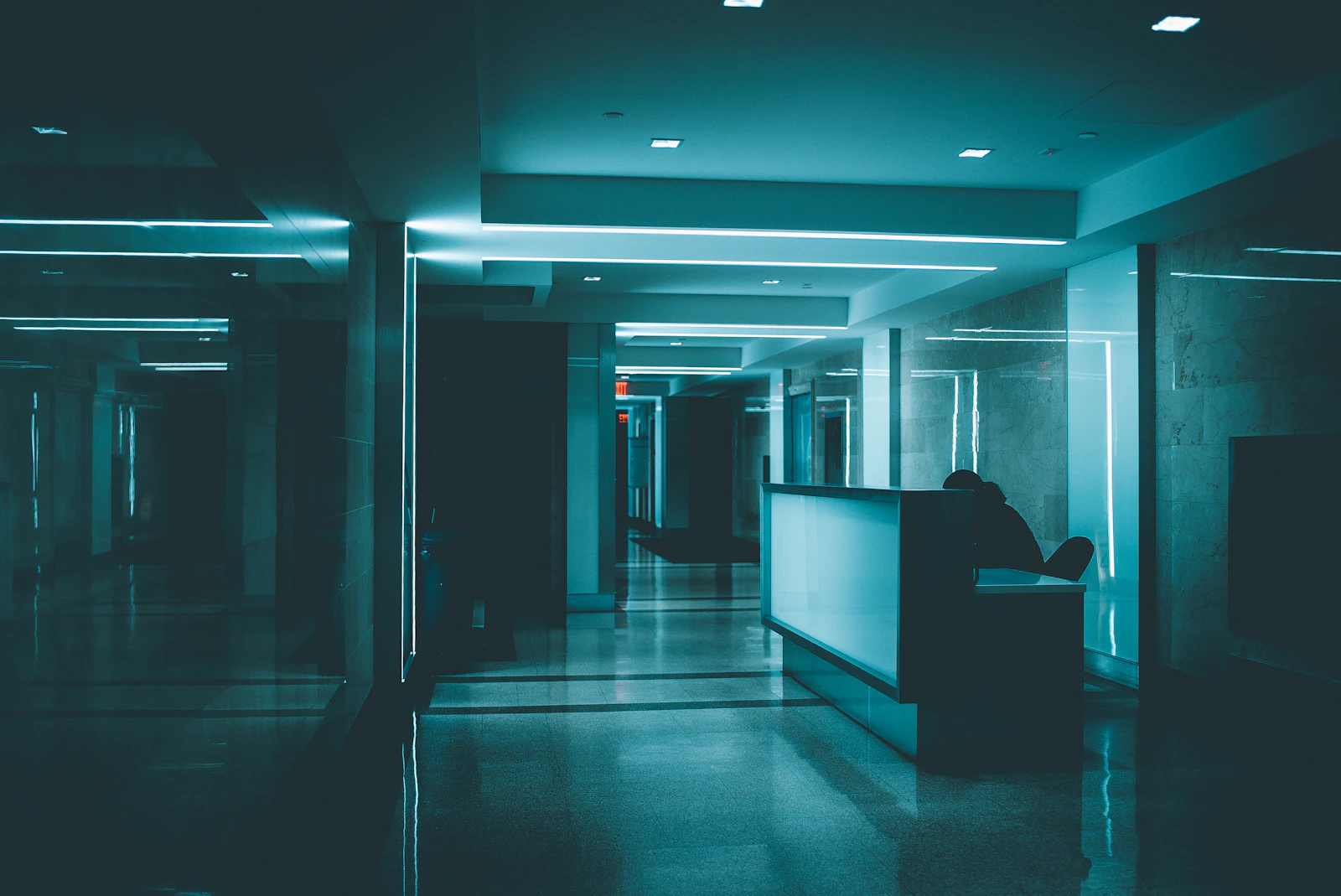 White wooden desk on hallway inside building