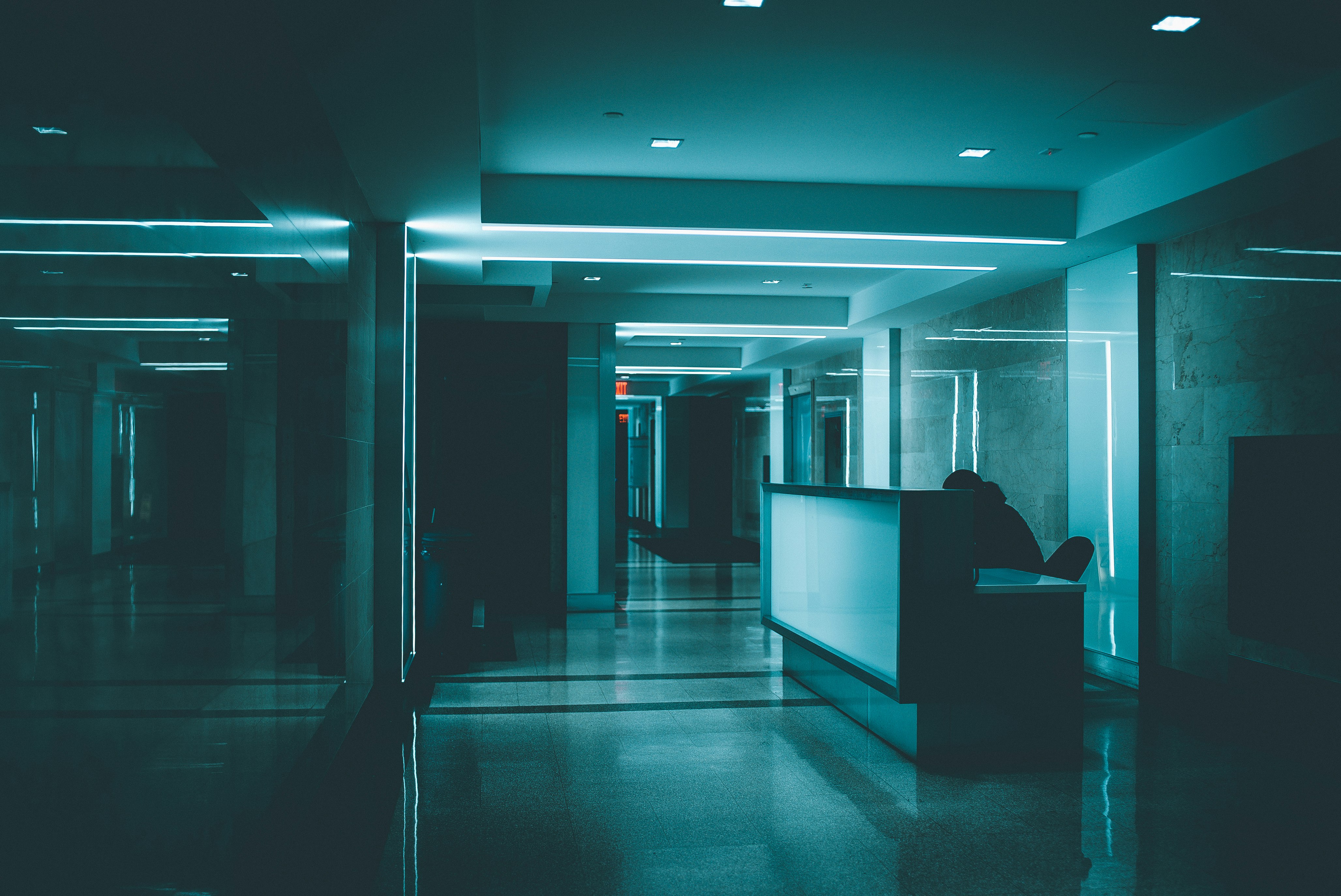 white wooden desk on hallway inside building