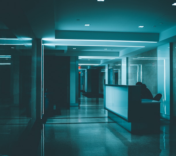 white wooden desk on hallway inside building