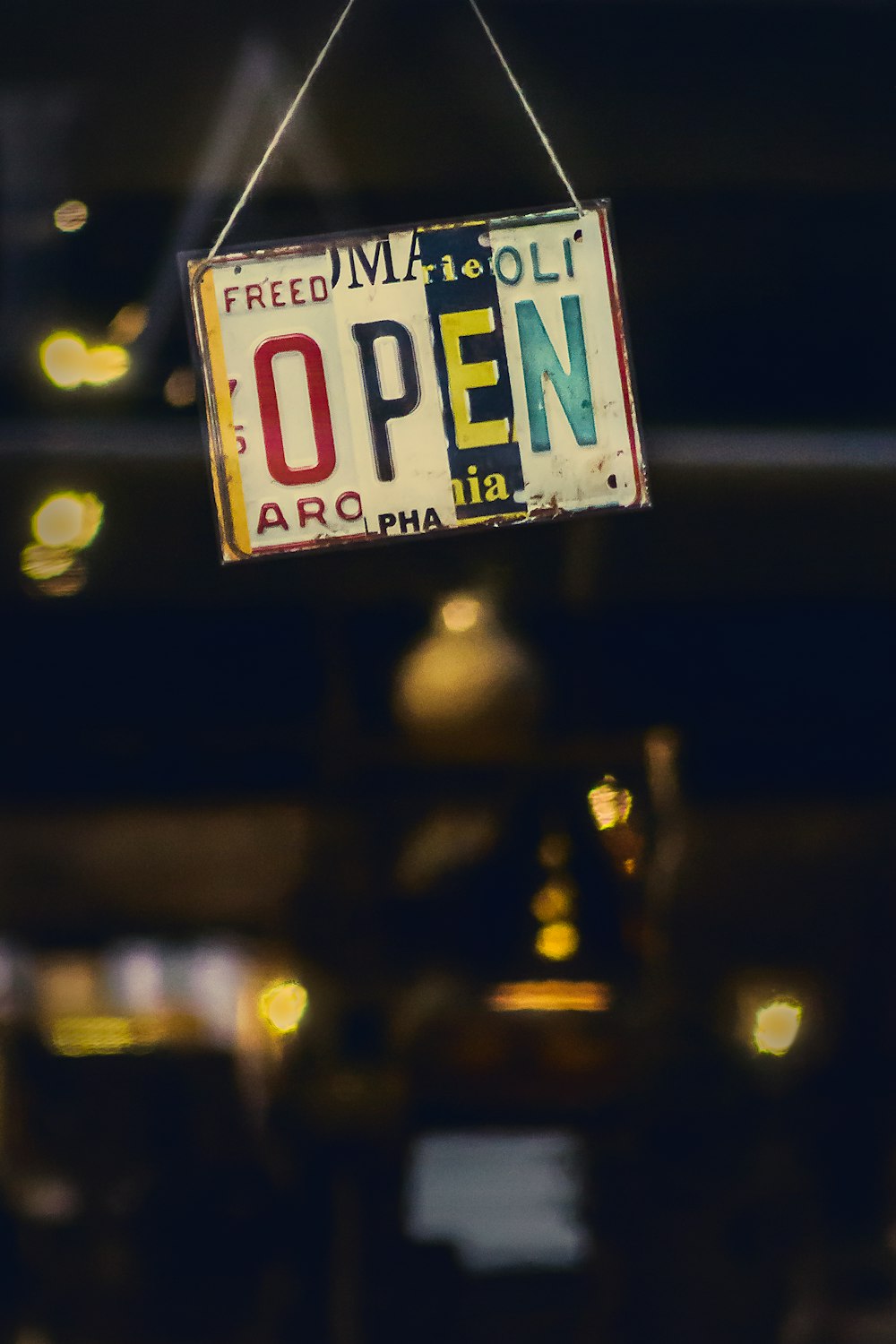 selective focus photography of licensed plate with open text hanged