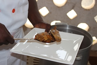 A professional chef preparing a variety of chicken dishes in a kitchen.