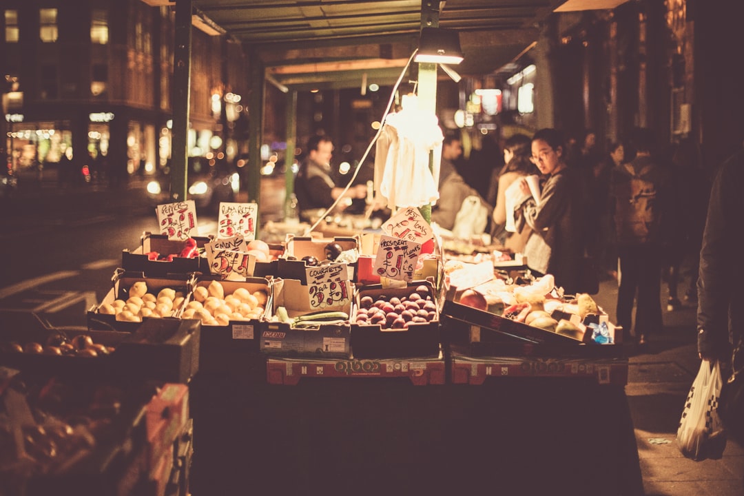 people on fruit stall beside road