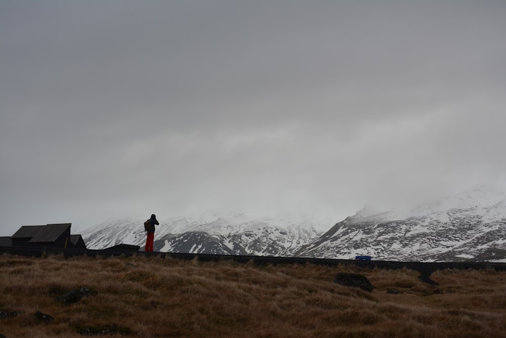 person standing front of mountain