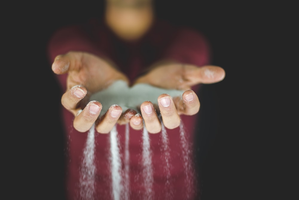 person holding blue sand