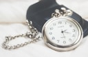 round silver-colored Dawn analog pocket watch
