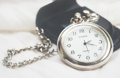 round silver-colored Dawn analog pocket watch